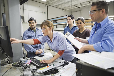 Safety inspection consultant talking with shop employees